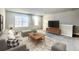 Comfortable living room with a sectional sofa, wooden coffee table, and large windows at 5350 Pine Lilly Dr, St Cloud, FL 34771