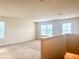Bright loft space with multiple windows, carpet flooring, and neutral wall color at 5350 Pine Lilly Dr, St Cloud, FL 34771