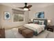 Cozy primary bedroom suite with a ceiling fan, and mountain views from a large window at 5350 Pine Lilly Dr, St Cloud, FL 34771