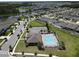 Aerial view of community pool including lounge chairs, tables, and landscaping at 5350 Pine Lilly Dr, St Cloud, FL 34771