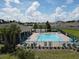 Community pool area surrounded by lounge chairs and tropical landscaping at 5350 Pine Lilly Dr, St Cloud, FL 34771