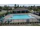 The community pool has lounge chairs, a covered area, and mature landscaping at 5350 Pine Lilly Dr, St Cloud, FL 34771
