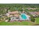 Community pool and clubhouse surrounded by palm trees and green spaces, offering a luxurious lifestyle at 636 Grand Canal Dr, Kissimmee, FL 34759