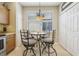 Cozy breakfast nook with a pendant light fixture and a window offering natural light at 636 Grand Canal Dr, Kissimmee, FL 34759