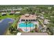 Aerial view of the community pool and recreation area, surrounded by palm trees and lush landscaping at 636 Grand Canal Dr, Kissimmee, FL 34759
