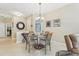 Cozy dining area adjacent to the living room, showcasing a round table and stylish chandelier at 636 Grand Canal Dr, Kissimmee, FL 34759