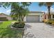 Inviting home exterior with a two-car garage, well-maintained lawn, and attractive curb appeal at 636 Grand Canal Dr, Kissimmee, FL 34759