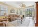 Bright living room with a ceiling fan, tile flooring, and sliding glass doors leading to an outdoor area at 636 Grand Canal Dr, Kissimmee, FL 34759