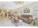 Relaxing living room featuring comfortable seating, soft lighting, and tile flooring throughout at 636 Grand Canal Dr, Kissimmee, FL 34759