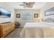Bright main bedroom featuring a dresser, a ceiling fan, and natural light through a window at 636 Grand Canal Dr, Kissimmee, FL 34759