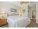 Comfortable main bedroom with a ceiling fan, a ceiling fan, and an ensuite bathroom entrance at 636 Grand Canal Dr, Kissimmee, FL 34759