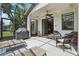 Enjoy this covered patio with ceiling fan, grill, and sun chairs perfect for entertaining or relaxing outdoors at 636 Grand Canal Dr, Kissimmee, FL 34759