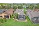 Aerial view showcasing the back of the home, with a screened-in patio and meticulously landscaped backyard at 636 Grand Canal Dr, Kissimmee, FL 34759