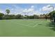 Well-maintained tennis court surrounded by lush greenery, offering a great recreational amenity at 636 Grand Canal Dr, Kissimmee, FL 34759