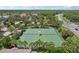 Aerial shot showcasing the community's well-maintained tennis courts with beautiful landscaping and easy access at 636 Grand Canal Dr, Kissimmee, FL 34759