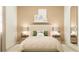 Calm bedroom featuring a neatly made bed, two bedside tables with lamps, and a decorative mirror at 773 Tundra Loop, Groveland, FL 34736