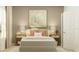 Comfortable bedroom featuring a large neutral art piece and symmetrical lighting on the bedside tables at 773 Tundra Loop, Groveland, FL 34736