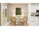 Cozy dining area with a round table, four chairs, and sliding glass doors for natural light at 773 Tundra Loop, Groveland, FL 34736