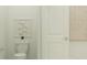 Clean half bathroom with a standard toilet, framed art and woven wall decor at 773 Tundra Loop, Groveland, FL 34736