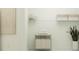 Well-organized laundry room with white walls, shelving, and a convenient rolling sorter at 773 Tundra Loop, Groveland, FL 34736
