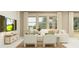 Bright living room featuring comfortable seating, decorative pillows, and an entertainment center at 773 Tundra Loop, Groveland, FL 34736