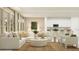 Open-concept living room featuring comfortable seating, neutral decor, and an adjacent modern kitchen at 773 Tundra Loop, Groveland, FL 34736