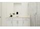 Elegant bathroom features a sleek vanity, modern fixtures and a glass-enclosed shower that creates a spa-like experience at 809 Tundra Loop, Groveland, FL 34736