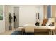 Bright bedroom features neutral colors, a blue-striped rug, large windows and a spacious walk-in closet for optimal storage at 809 Tundra Loop, Groveland, FL 34736