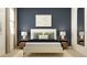 Stylish bedroom with a cozy bed, a blue accent wall, modern decor, and two sleek nightstands at 809 Tundra Loop, Groveland, FL 34736