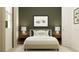 Charming bedroom with car-themed art, soft neutral tones, and two matching nightstands and lamps at 809 Tundra Loop, Groveland, FL 34736