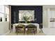 Elegant dining room with navy wall, a white table, seating for six, and modern decor at 809 Tundra Loop, Groveland, FL 34736