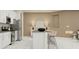 Stylish kitchen featuring stainless steel appliances, a gray countertop, and seating around the island at 809 Tundra Loop, Groveland, FL 34736