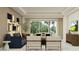 Bright living room with neutral tones, comfortable seating, and access to an outdoor area at 809 Tundra Loop, Groveland, FL 34736