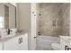 Modern bathroom featuring stylish tile, a tub, and a sleek black framed mirror over a white vanity at 811 E Mcdonald Ave, Eustis, FL 32726