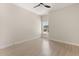 Bright bedroom with a ceiling fan, light-colored walls, wood floors, and a view from the window at 811 E Mcdonald Ave, Eustis, FL 32726
