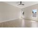 Bright bedroom with two windows, wood floors and a modern ceiling fan perfect for relaxation and comfort at 811 E Mcdonald Ave, Eustis, FL 32726