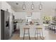 Open kitchen boasts a large island with bar seating and modern pendant lights at 811 E Mcdonald Ave, Eustis, FL 32726