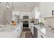Bright kitchen features white cabinets, stainless steel appliances, and stylish pendant lighting at 811 E Mcdonald Ave, Eustis, FL 32726