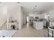 Open-concept kitchen with an island, white cabinets, and stainless steel appliances at 811 E Mcdonald Ave, Eustis, FL 32726
