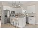 Bright kitchen featuring white cabinetry, stainless appliances, and an island with bar seating at 811 E Mcdonald Ave, Eustis, FL 32726