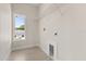 Neat laundry room features wood floors, a storage shelf, and a window, offering a practical space at 811 E Mcdonald Ave, Eustis, FL 32726