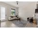 A bright living room featuring a white sofa, large window, and light wood floors at 811 E Mcdonald Ave, Eustis, FL 32726