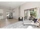 Open-concept living area with stylish furniture and access to the balcony at 811 E Mcdonald Ave, Eustis, FL 32726