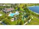 Aerial view of community pool, miniature golf, and clubhouse surrounded by lush landscaping and a pond at 8256 Bayview Crossing Dr, Winter Garden, FL 34787