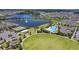 Aerial view showcasing community amenities, including a pool, tennis courts, park, and surrounding homes and lakes at 8256 Bayview Crossing Dr, Winter Garden, FL 34787