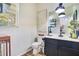Half bath features a vanity with modern fixtures and wall art, and a window at 8256 Bayview Crossing Dr, Winter Garden, FL 34787