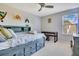 Bedroom with a custom bed frame with built-in storage and drawers, plus a seating area and natural light at 8256 Bayview Crossing Dr, Winter Garden, FL 34787