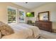 Inviting bedroom featuring a bed, side tables, large windows, and neutral color scheme at 8256 Bayview Crossing Dr, Winter Garden, FL 34787