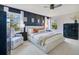 Stylish bedroom featuring a decorative wall, plush carpet, and large windows at 8256 Bayview Crossing Dr, Winter Garden, FL 34787