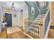 Entryway with wood flooring, stairs with wooden railing, and an ornate hanging light fixture at 8256 Bayview Crossing Dr, Winter Garden, FL 34787